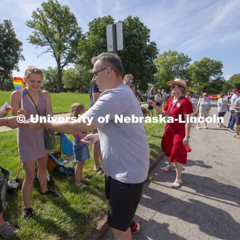 Chancellor Ronnie Green and his wife, Jane, hand out Husker Pride stickers along the Star City Pride parade route on June 19. Multiple university administrator participated in the event. Star City Pride parade on June 19, 2021. Photo by Troy Fedderson / University Communication